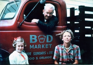 Joy Wallace Dickinson (left) with grandparents Bill and Alice Wallace and the truck for the family's new business, the B&D Market in Winter Park.