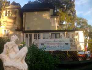 Half of the historic Capen House rests after its move in Winter Park, Fla., near a statue of Pan at the Albin Polasek Museum and Sculpture Gardens.